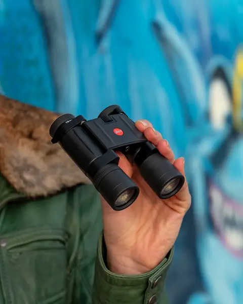 A woman holding the Trinovid BCA