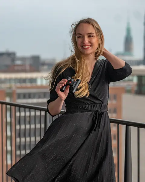 A woman in a black dress holding the Ultravid