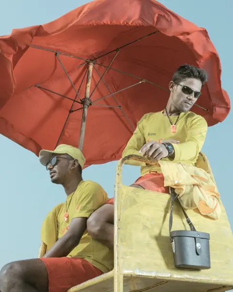 Men with yellow clothes at the beach