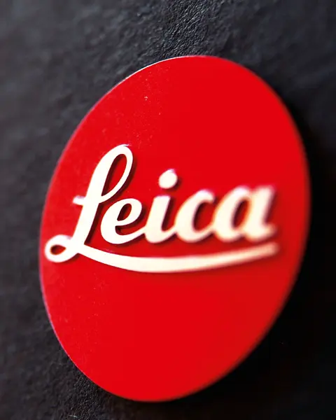 Close-up of the red Leica logo on a black background