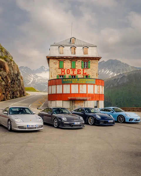 Split screen of four Porsches in front of a hotel and a field of flowers in a mountainous landscape.