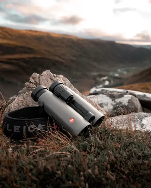 Leica-Noctivid-binoculars-lying-on-a-stone-in-the-Scottish-Highlands