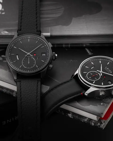 Two Leica Monochrom watches on a pile of books.