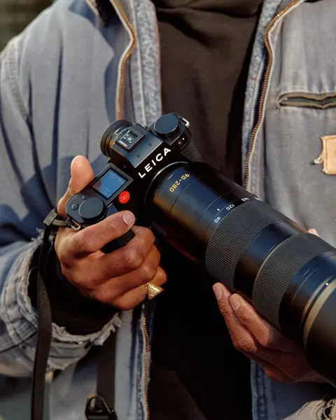 A man holding a Leica camera in his hand