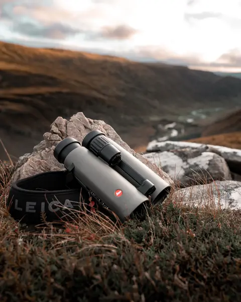 Leica-binoculars-Noctivid-8x42-lying-on-a-stone-in-the-Scottish-Highlands