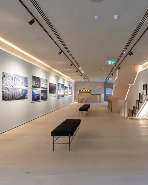Exhibition room with photographs from Antarctica and a description of the photo project ‘Colours of Antartica’ by Stuart Robertson.