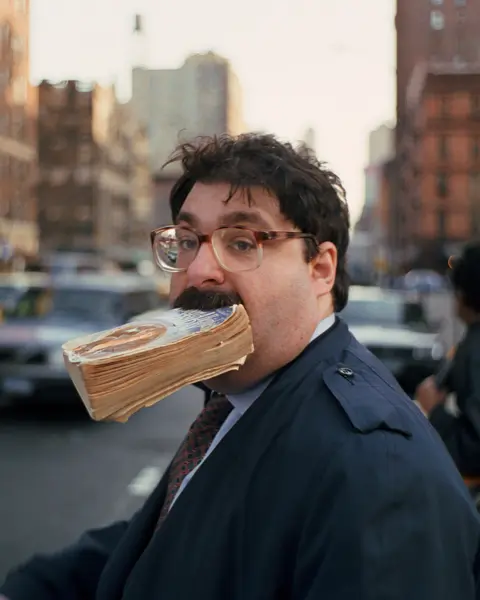 Man with a book in his mouth