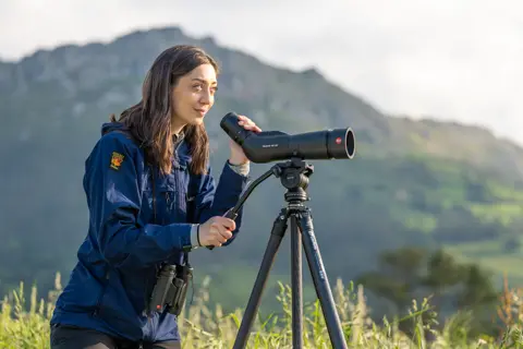 Woman is looking through her Leica Televid HD spotting scope