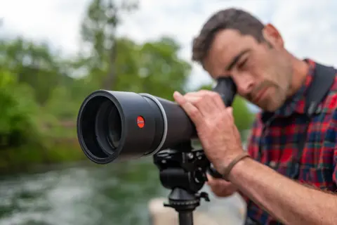 Man is looking through his Leica APO-Televid spotting scope