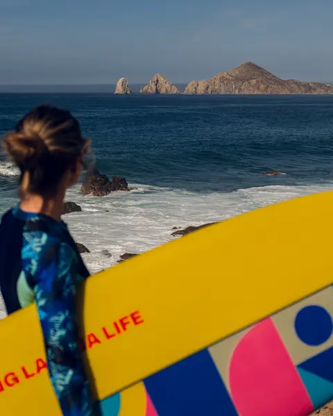 Woman with a surfboard under her arm