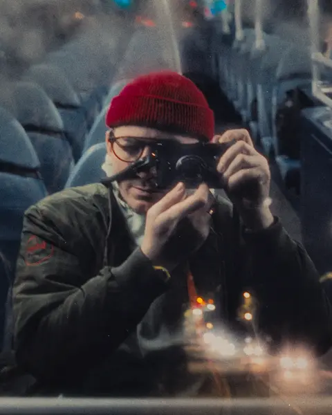 Man in a Bus with leica camera