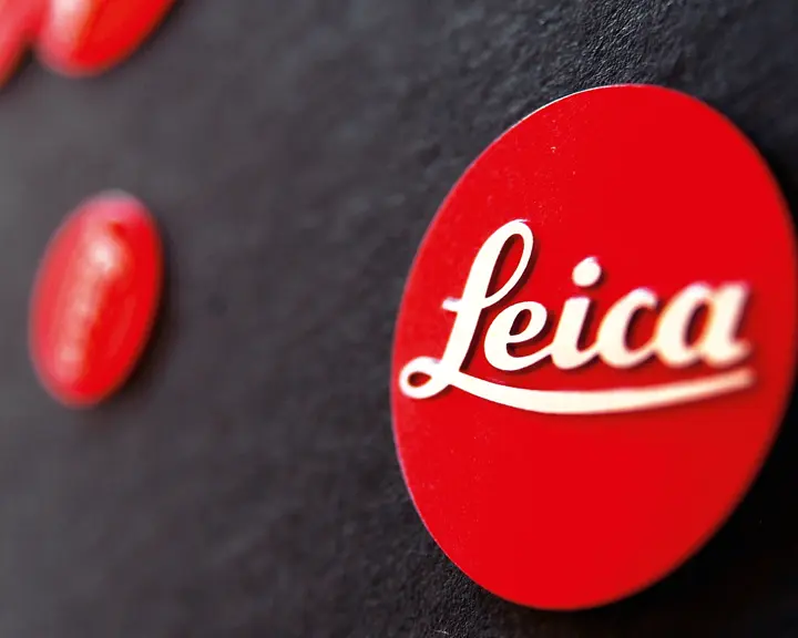 Close-up of the red Leica logo on a black background