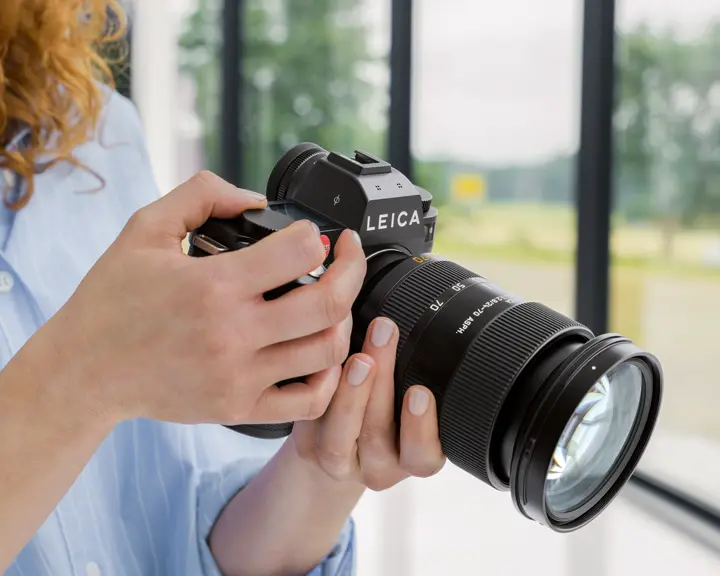 Woman holding a camera in her hands
