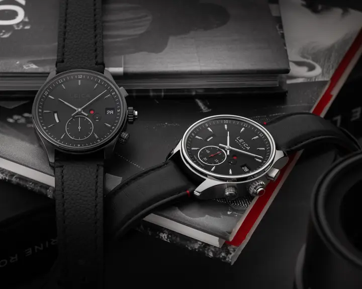 Two Leica Monochrom watches on a pile of books.