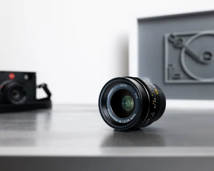 Leica camera with a lens on a table.