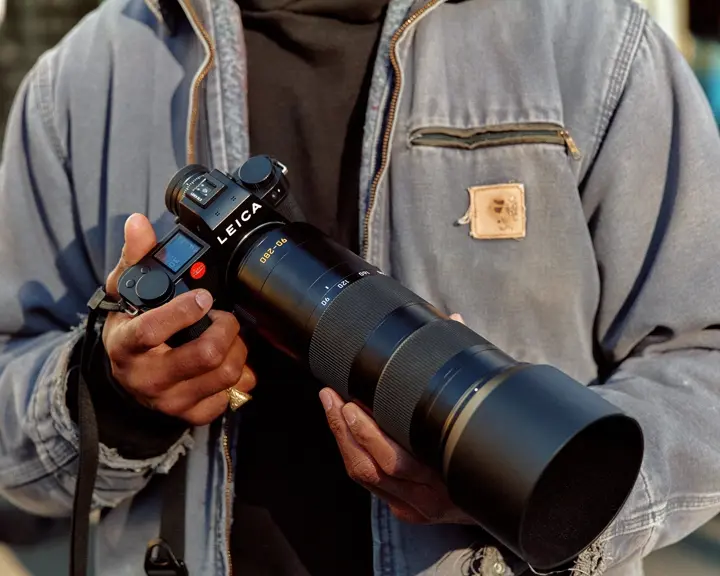 A man holding a Leica camera in his hand