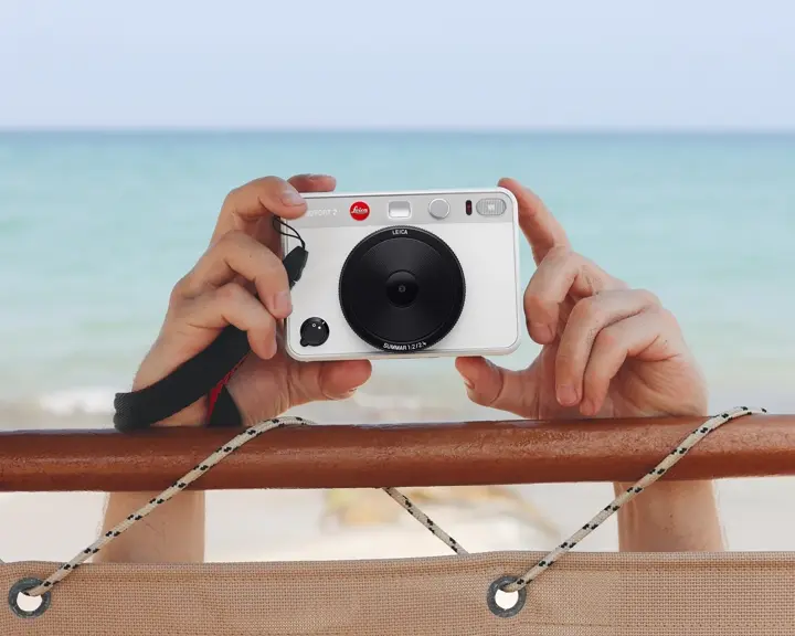 White Leica sofort Camera at the beach