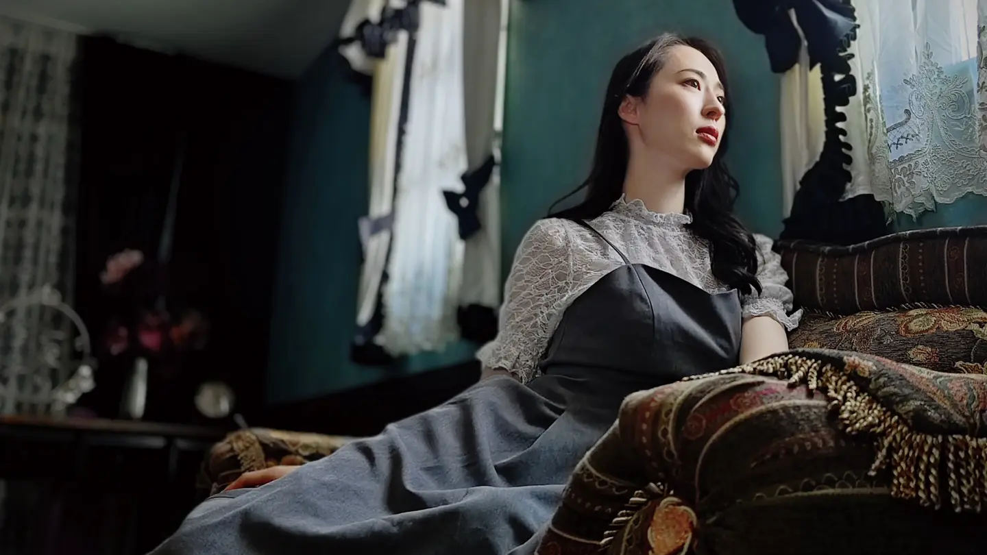 Woman sitting on a sofa and looking out of the window