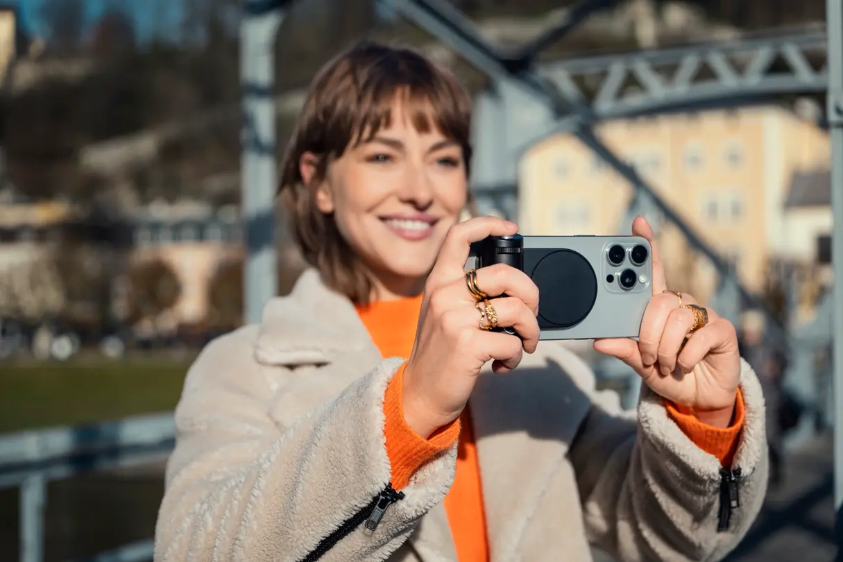 Woman smiling while using the Leica LUX grip