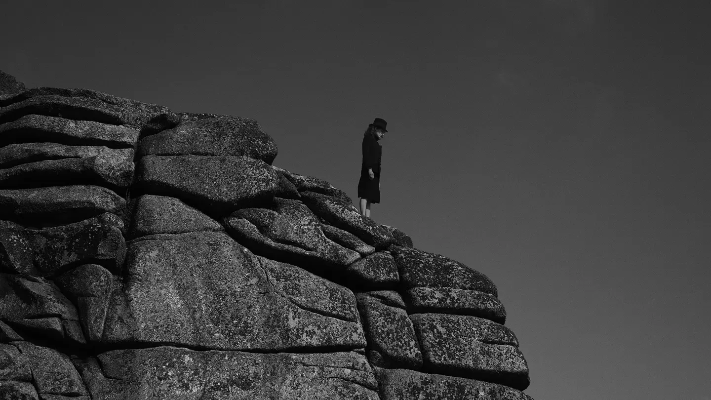 Woman standing on a cliff