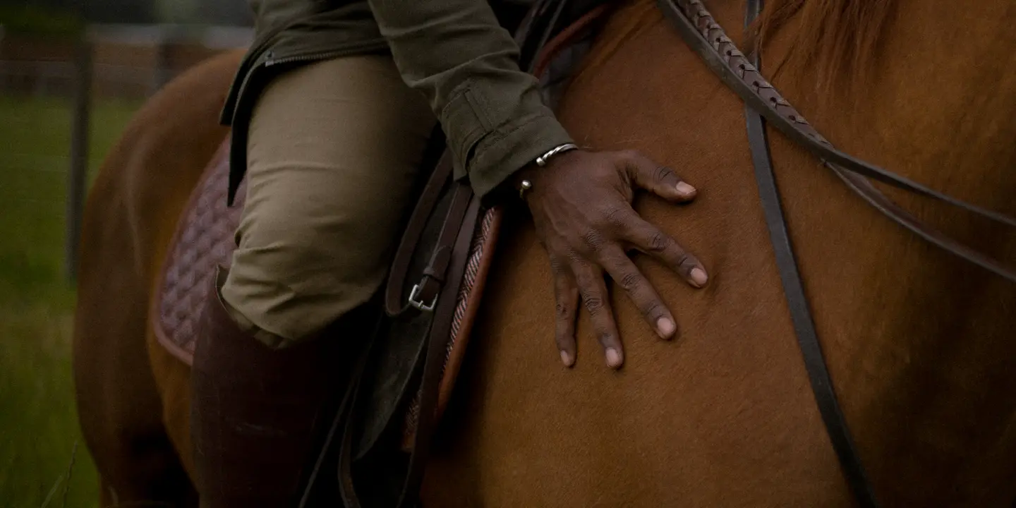 Close-up of a person sitting on a horse