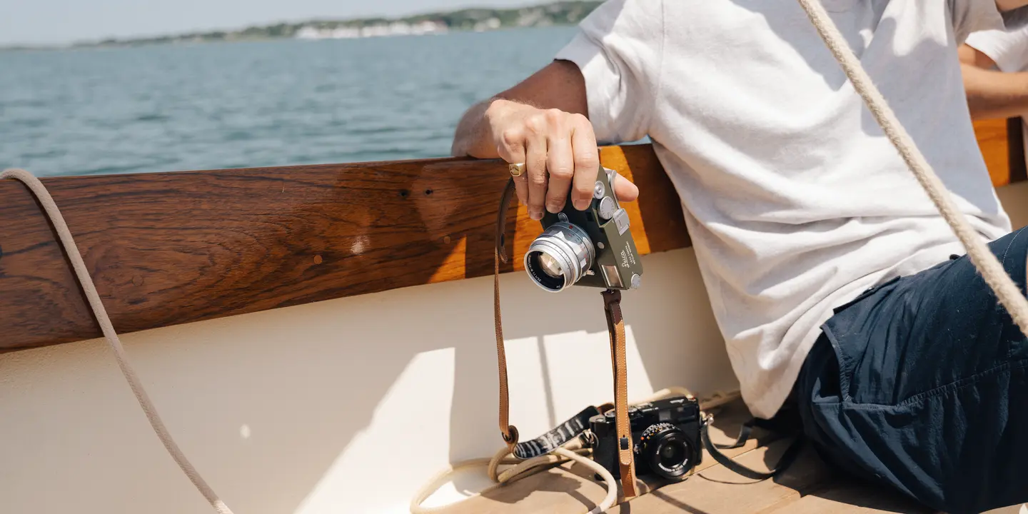 Riley on a boat with his Leica in his hand