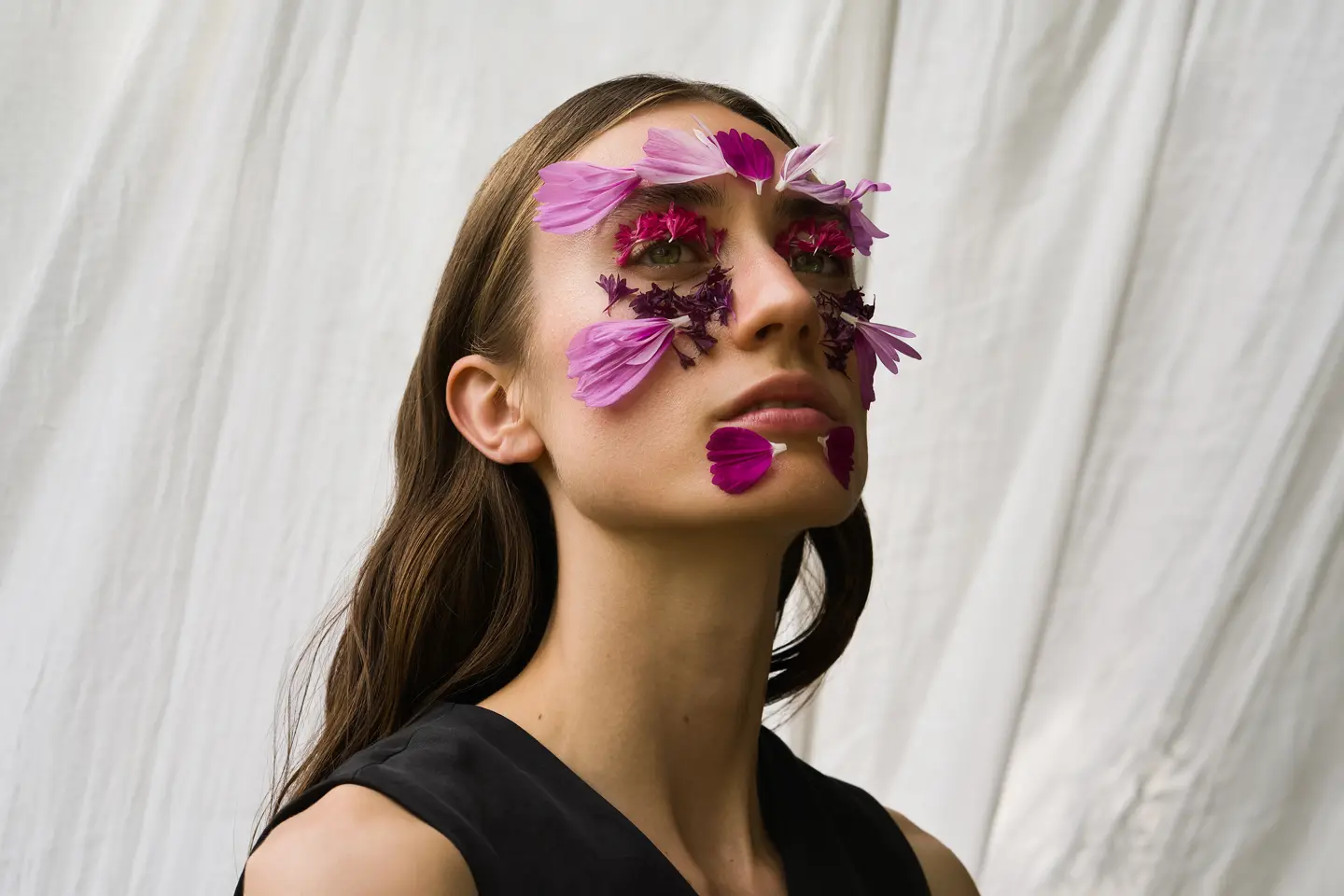 Portrait of a woman with flowers on her face skin