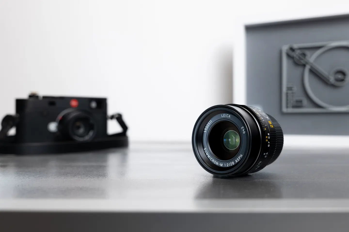 Leica camera with a lens on a table.