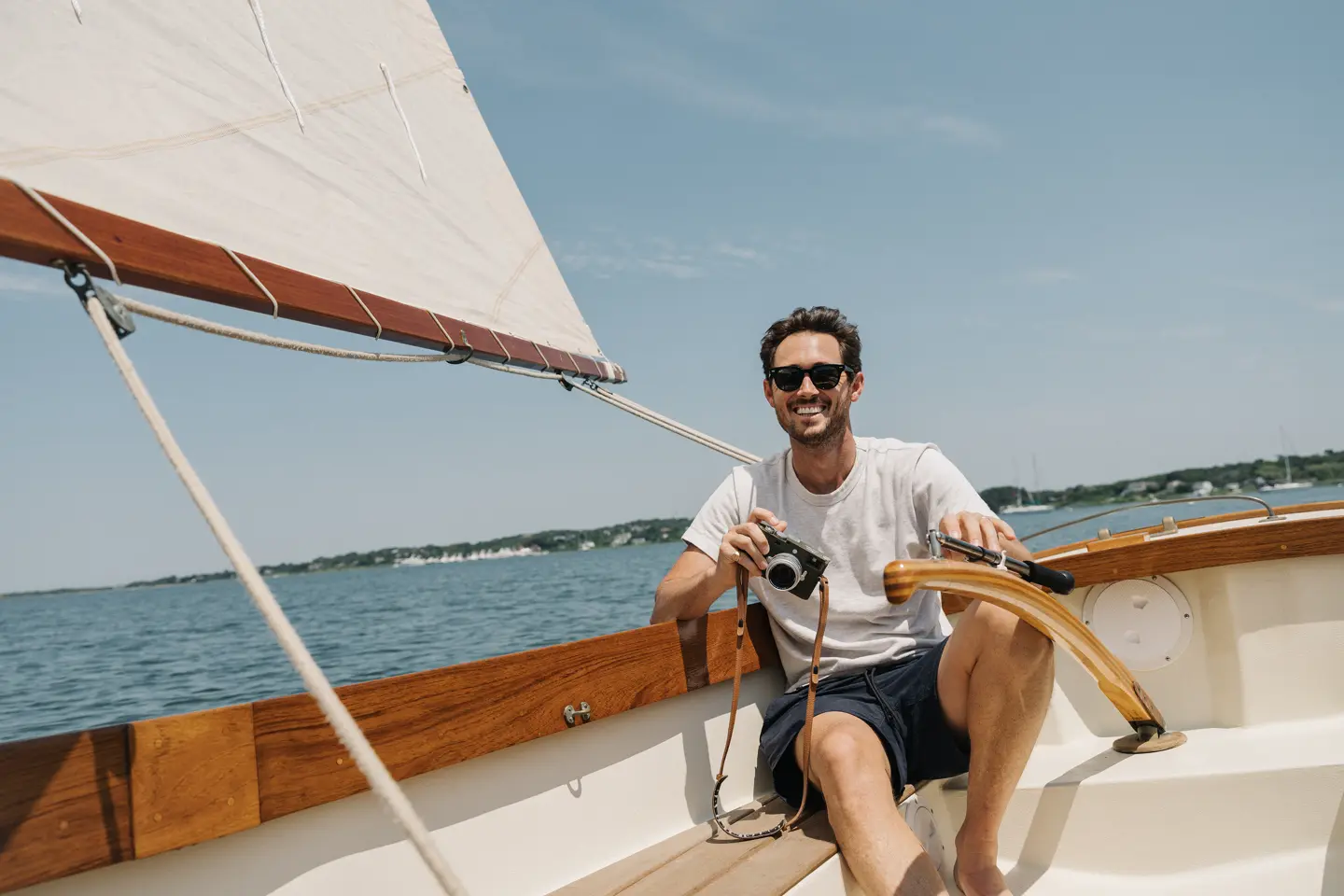 Riley on a boat with his Leica in his hand