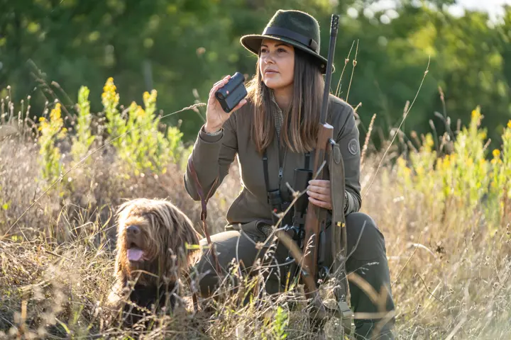 Woman with dog on the hunt