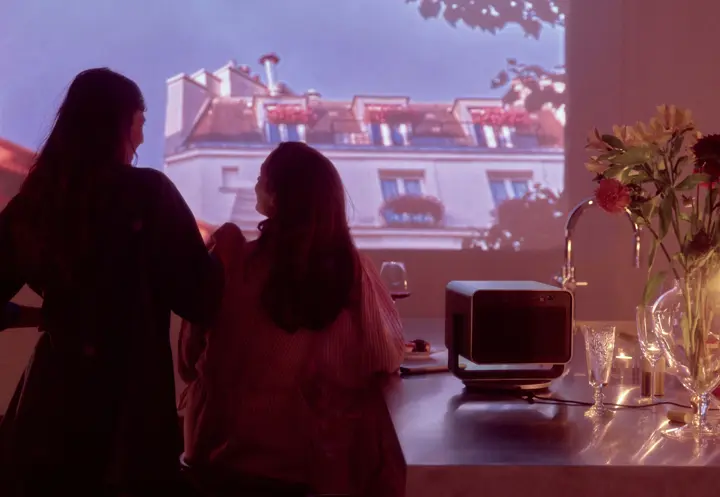 Two people watching a Leica Cine Play 1 projection.