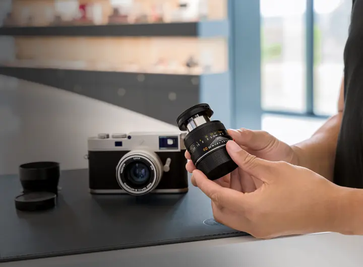Man holding Leica lens in his hands
