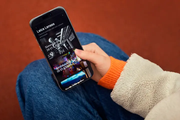 Woman using the Leica LUX app on her iPhone