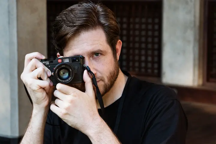 John Sypal taking a picture with a Leica M Camera.