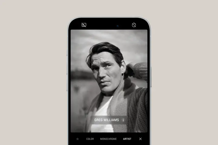 Smartphone shows portrait of a man looking into the distance in Greg Williams artist look