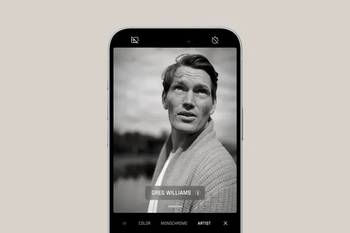 Smartphone shows portrait of a man looking into the distance in Greg Williams artist look