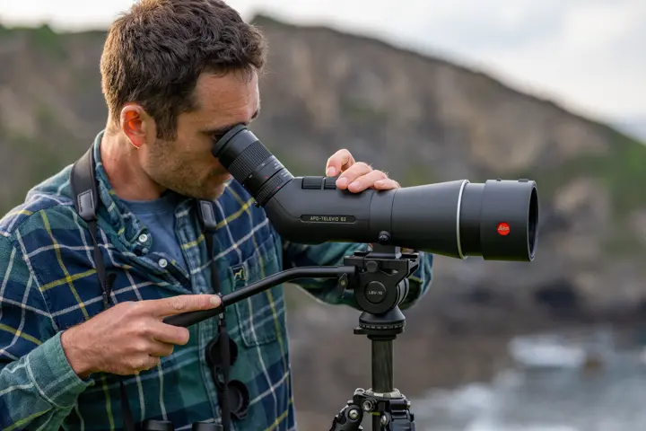 Man is looking through his Leica APO Televid spotting scope