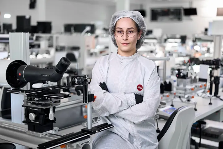 A Leica employee works on a Leica spotting scope