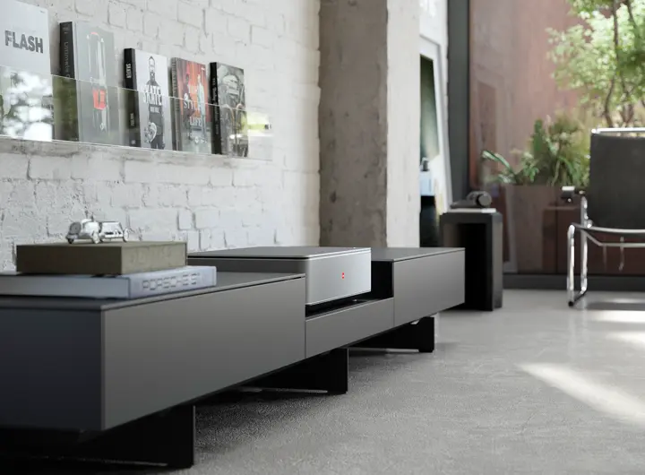 Leica Cine 1 on a Kettnaker TV lowboard in front of a wall.