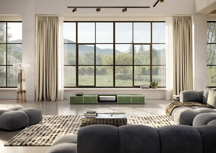 Leica Cine 1 on a USM TV lowboard in front of big windows.