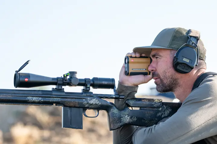 Man is looking through his Leica Rangemaster CRF MAX