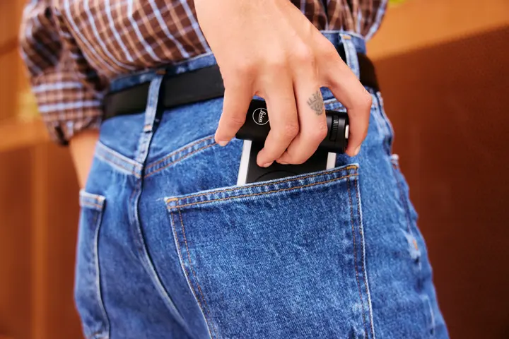 Woman with Leica LUX Grip in her back pocket