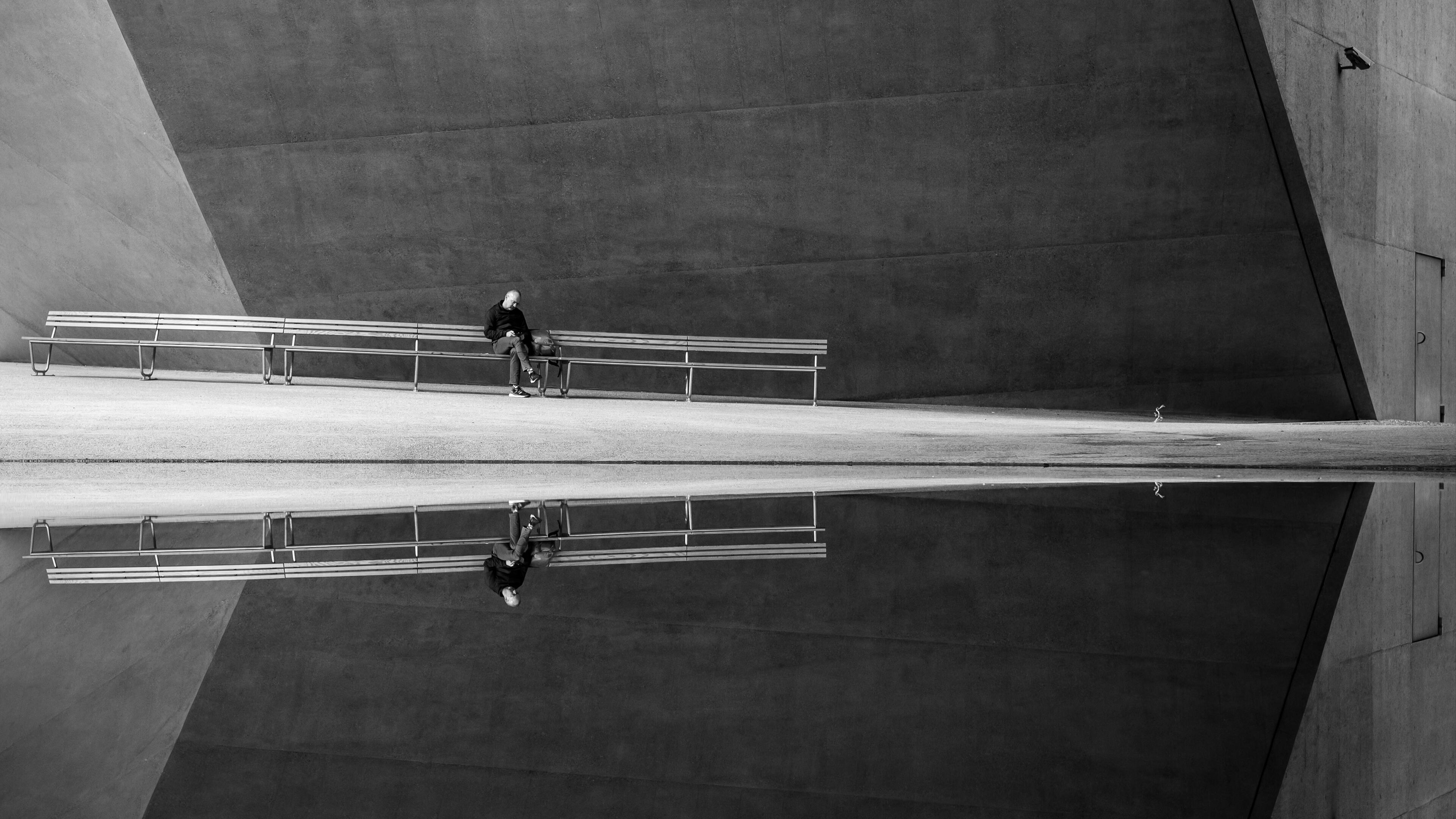 Black and white photography man sitting on a bench