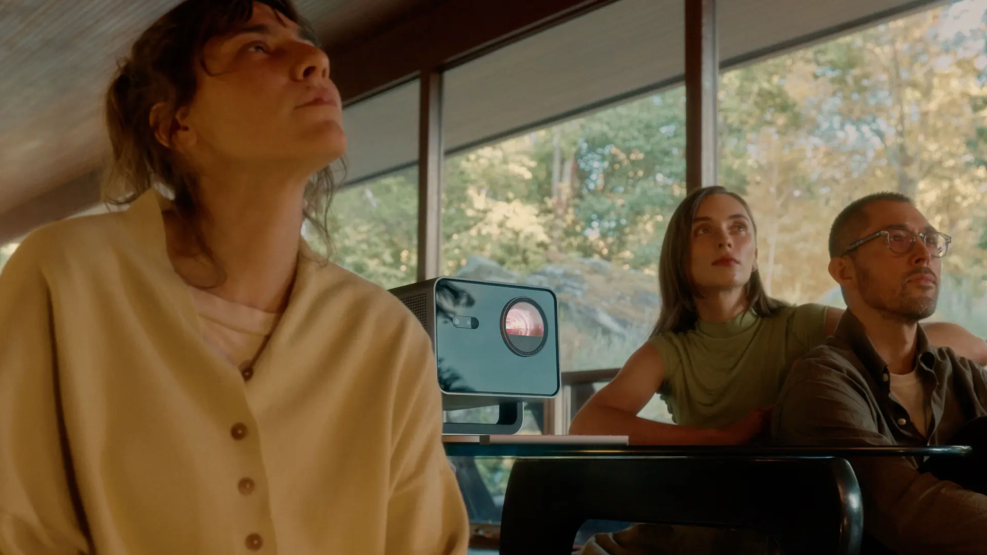 A group of three watching sth on the leica play 1